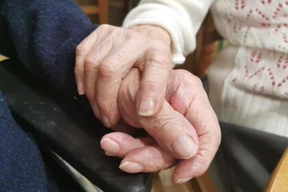 Two hands holding each other