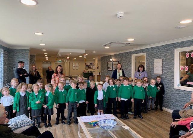 Local schoolchildren visiting residents for an intergenerational activity at Humberston House Care Home.